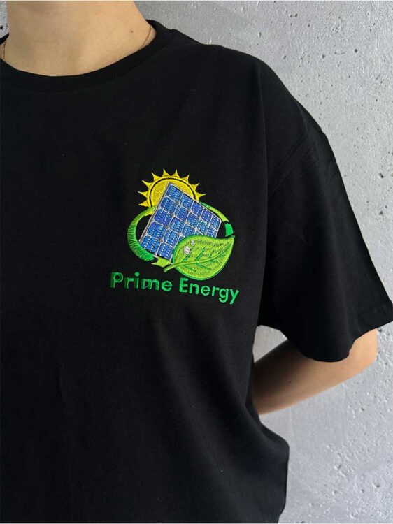 Вишивка логотипа на чорній футболці.